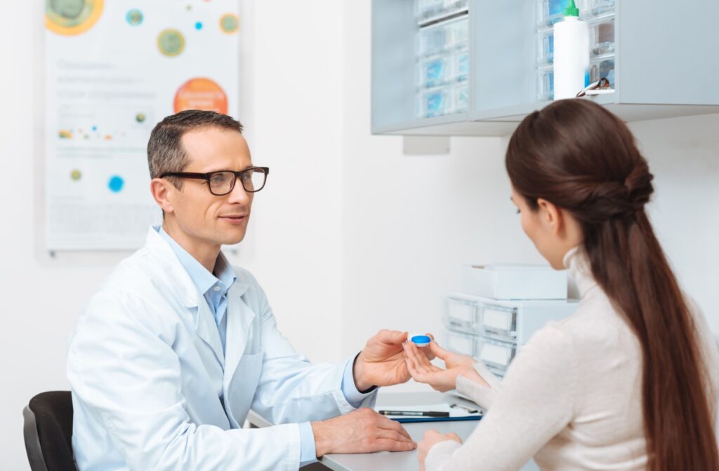 An eye doctor discusses contact lens options for astigmatism during a contact lens fitting.