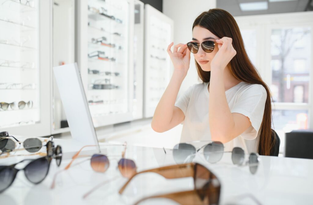 Woman trying on sample frames for prescription sunglasses