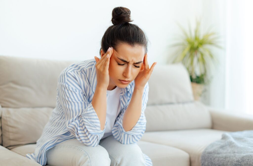 A person soothing their temples for headache relief.